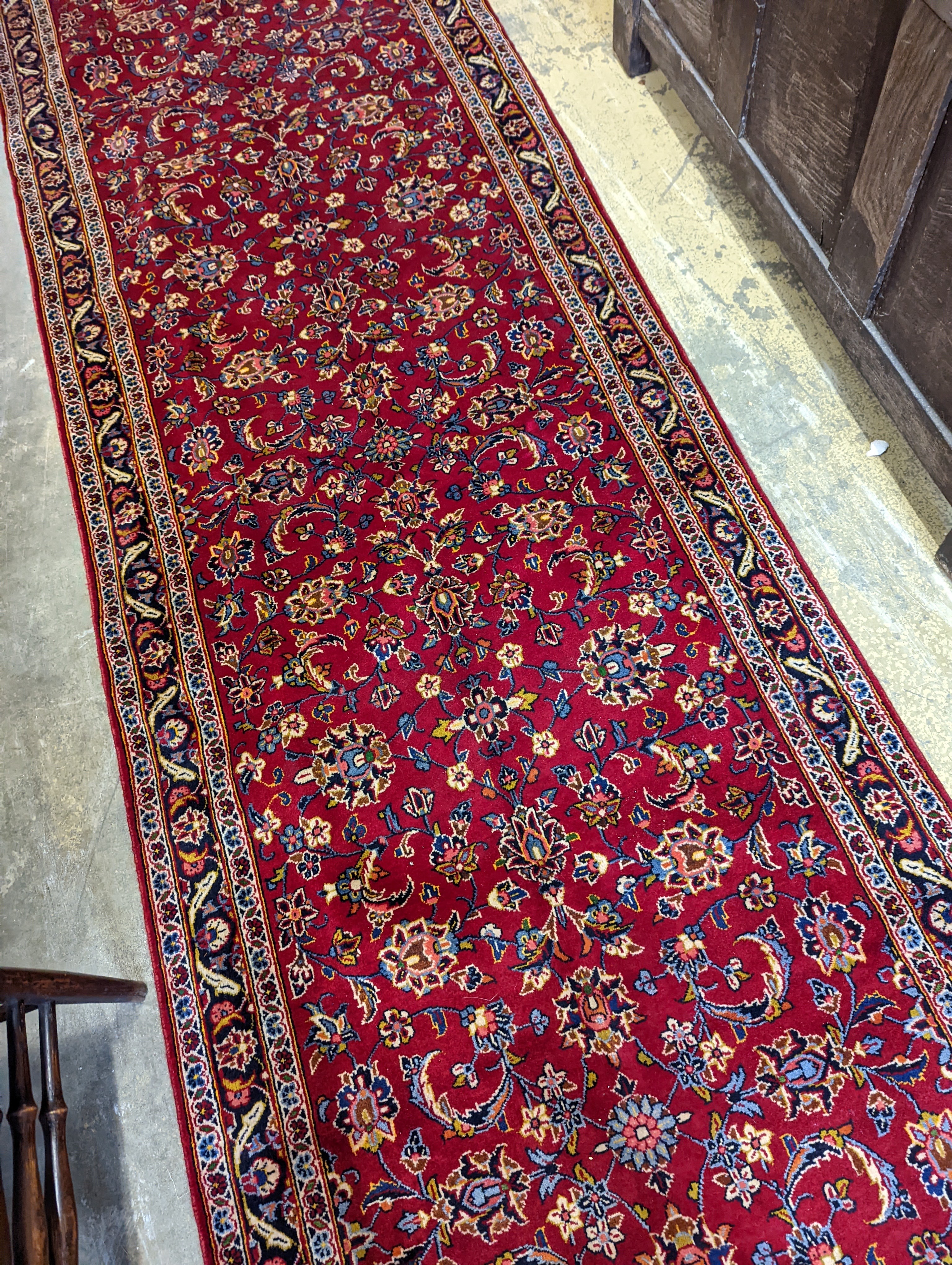 A Kashan red ground runner, 340 x 101cm